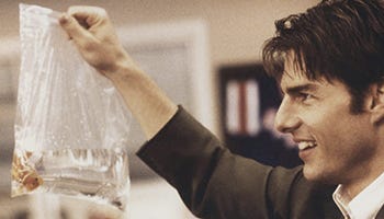Jerry Maguire played by Tom Cruise holding up a fish in a plastic bag that he is taking with him after leaving his job at an established major sports agency Jerry Maguire played by Tom Cruise holding up a fish in a plastic bag that he is taking with him after leaving his job at an established major sports agency