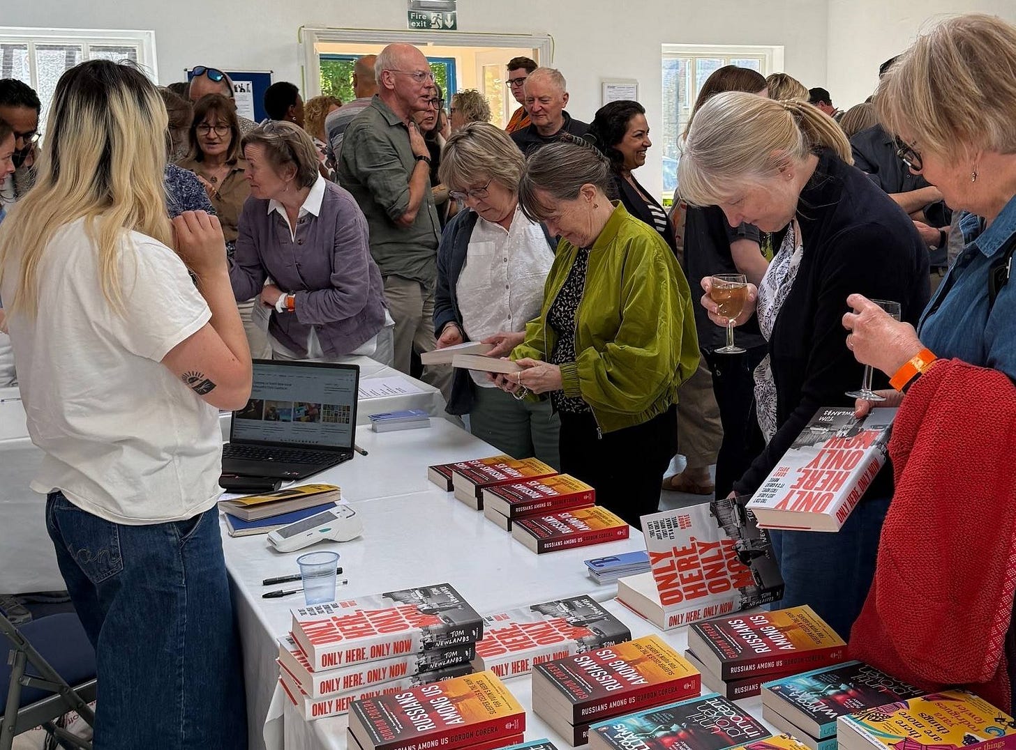 May be an image of 9 people, book, crowd and text