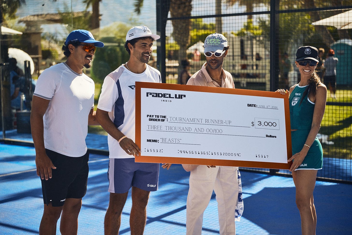 Players receiving runner's up prize check on a padel court in Indio, CA