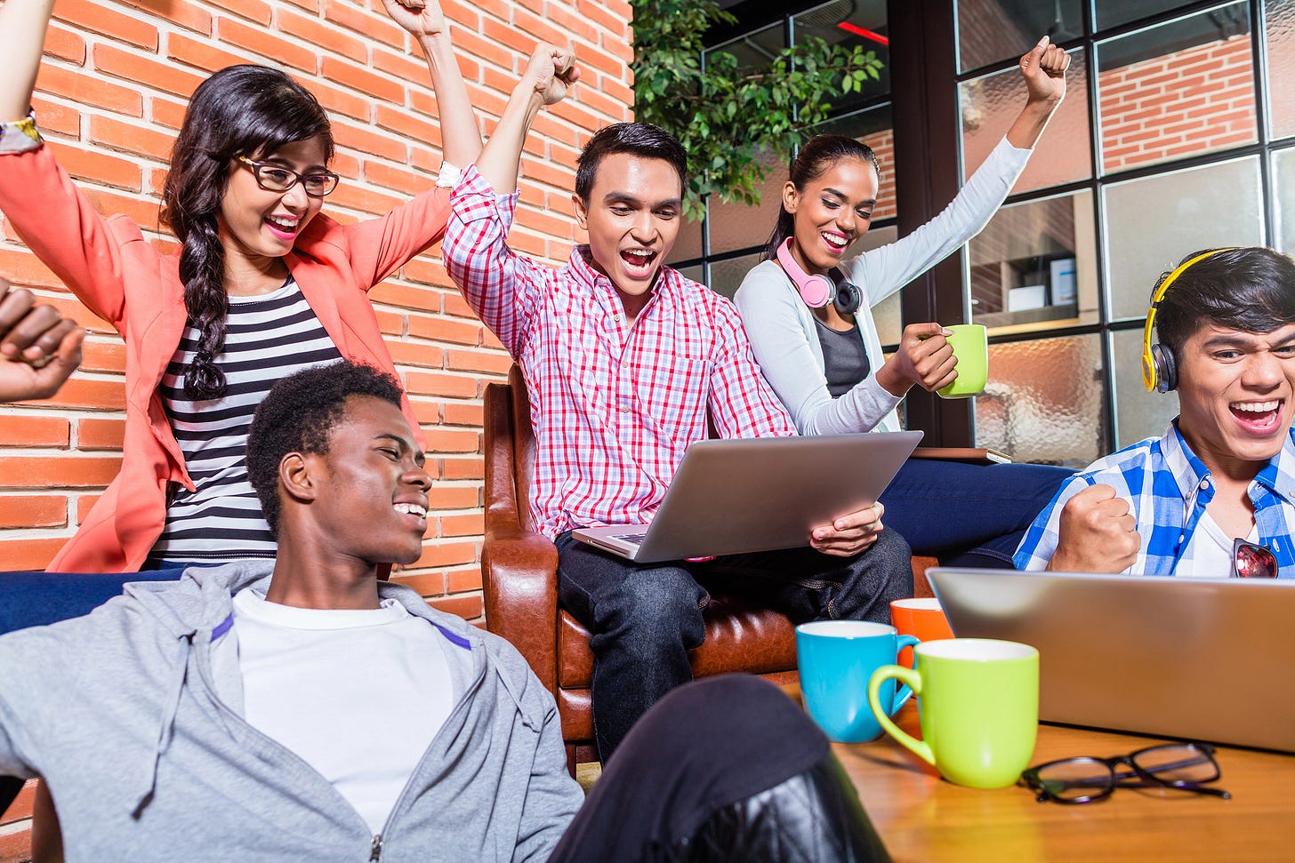 Diverse group of workers happy about their progress