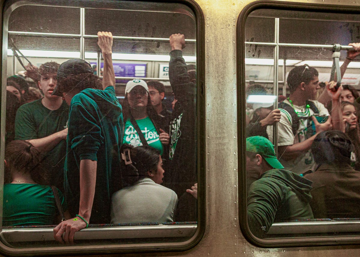 Packed MBTA subway car full of people in green clothing, likely heading to or from a St. Patrick’s Day event in Boston. Packed MBTA subway car full of people in green clothing, likely heading to or from a St. Patrick’s Day event in Boston.