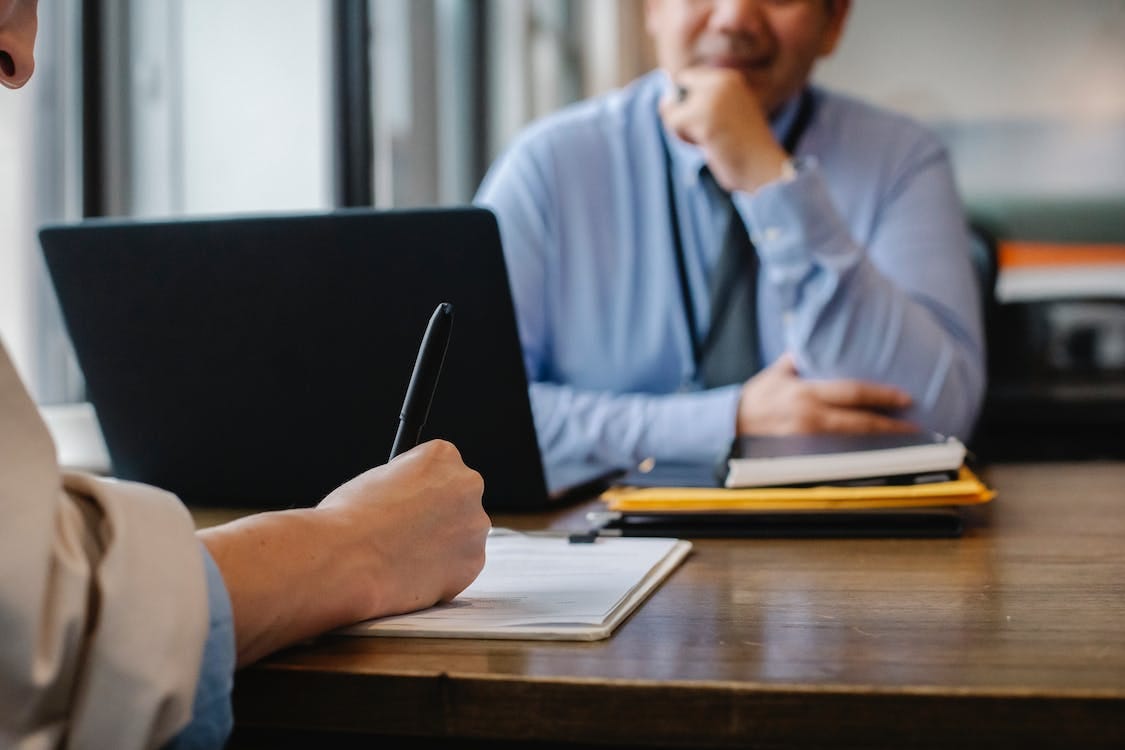 Free Crop anonymous female filling questionnaire when applying for job sitting in employer office Stock Photo Free Crop anonymous female filling questionnaire when applying for job sitting in employer office Stock Photo
