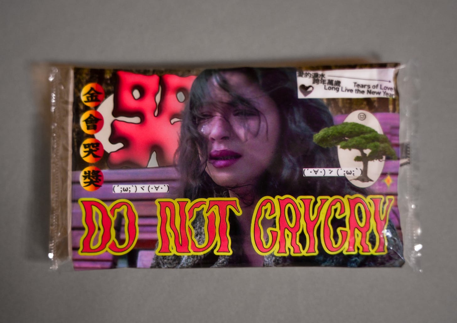 A plastic tissue packet with an image of a crying woman and the text "Do Not Crycry"