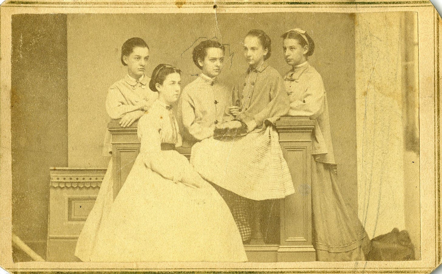 Group portrait of Victorian-era young women; one face marked with a small penciled circle identifying Caroline Bottum.