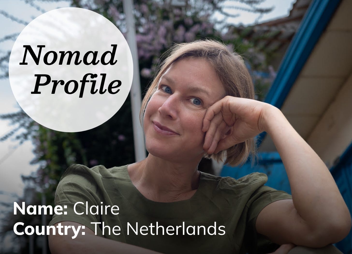 A white woman with short blond hair and light eyes is tilting her head and leaning on her hand. She is wearing a green short and looking directly at the camera with a slight smile.