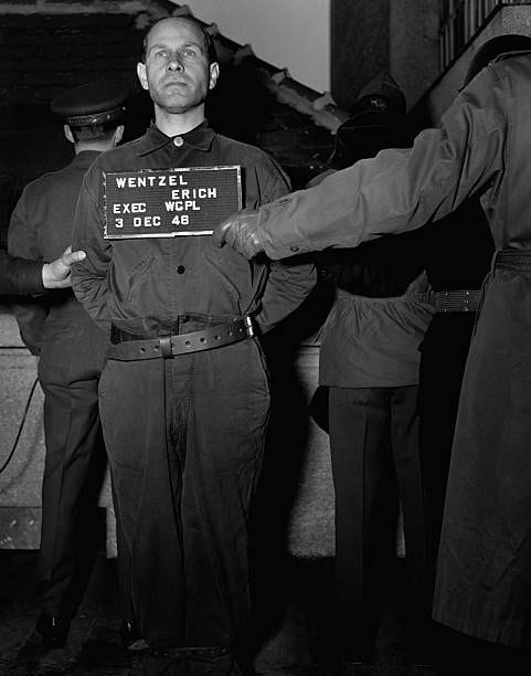 After the Nuremberg war crimes trials, convicted Nazi war criminal Erich Wentzel stands on the gallows, about to be hanged, ca. 1946.