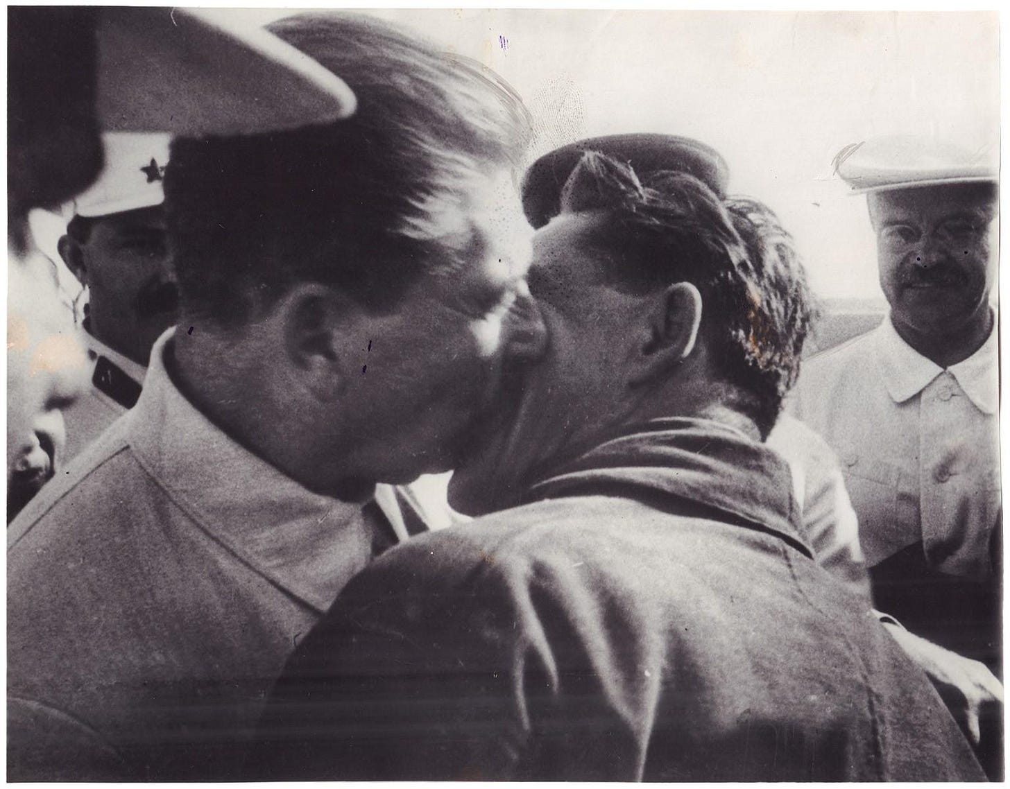 Soviet Premier Joseph Stalin publicly embraces pilot Vasily Molokov in 1937, a staged moment of Soviet propaganda.