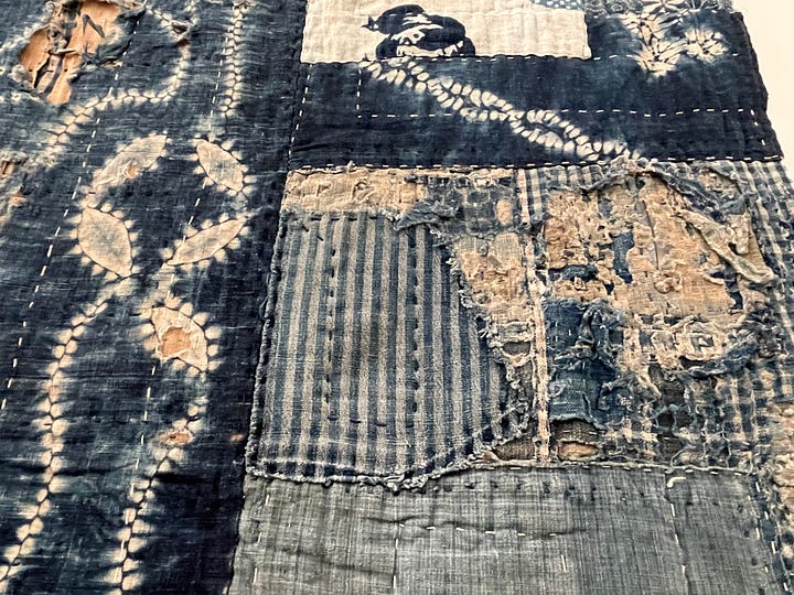 A quilt and a detail of the same quilt comprised of indigo blue dyed cotton fabric scraps.