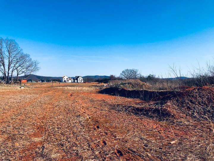 houses in a new neighborhood and a field before the new neighborhood was built