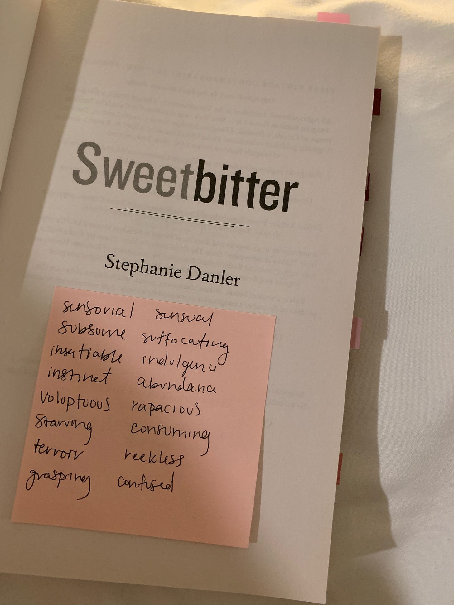 title page of Sweetbitter by Stephanie Danler. Pink post-it note stuck to the middle, with a list of handwritten words.