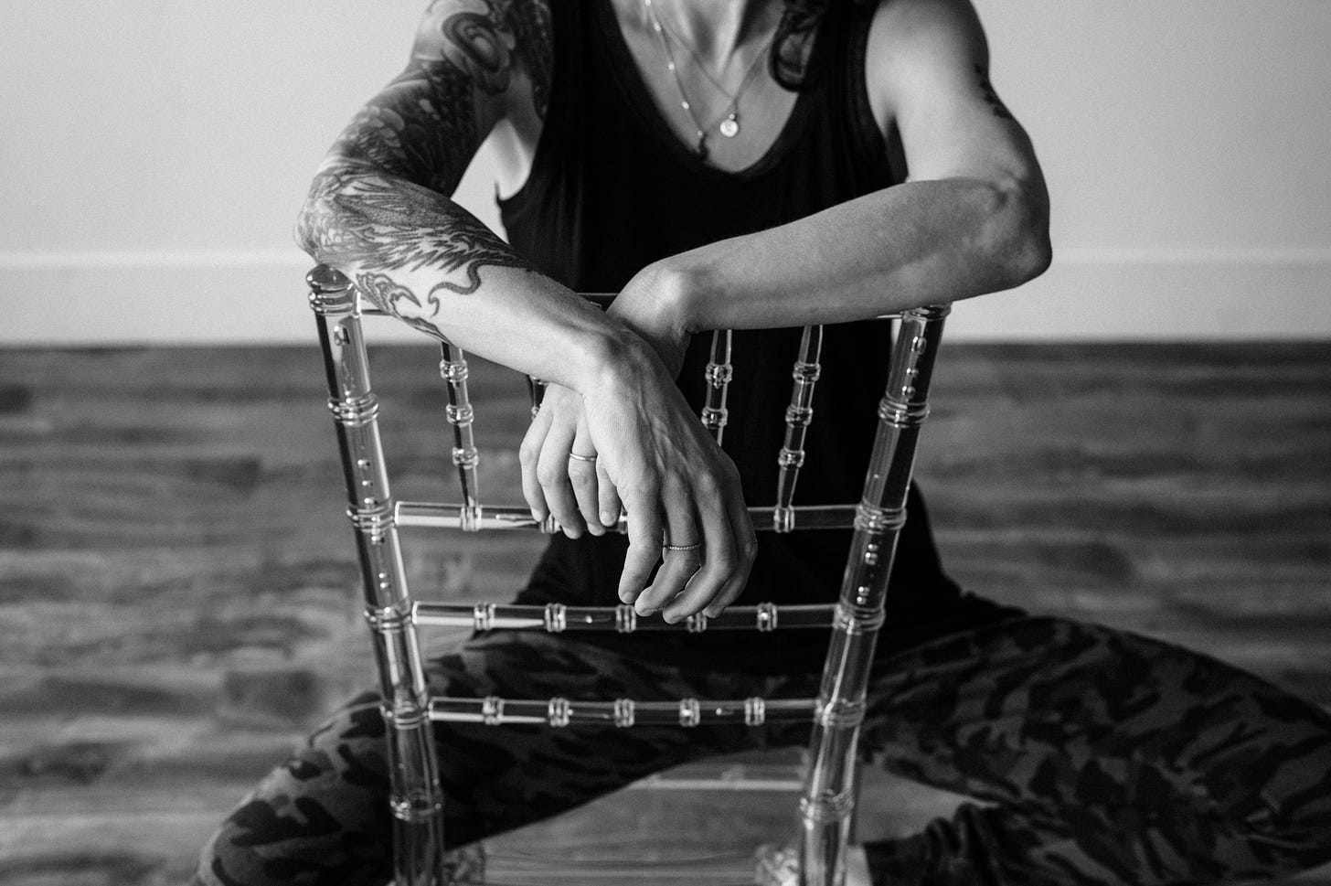 Author sitting backwards on chair with arms crossed