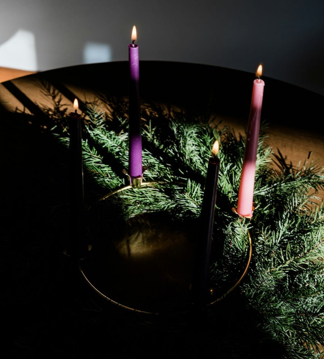 a group of candles sitting on top of a table a group of candles sitting on top of a table