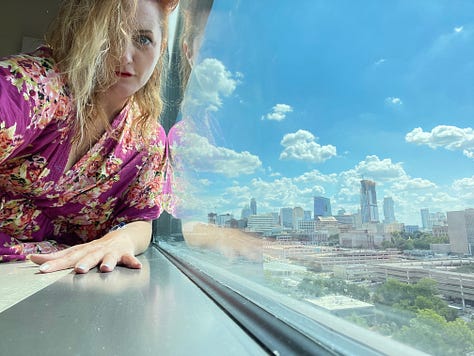 Becky, dressed in a gauzy floral nightgown, poses suggestively in her hospital room, appearing to strip dance around the IV pole, sip seductively from her plastic hospital jug, and pose suggestively with the "soiled linens" bin.