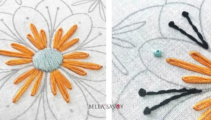 center of mandala stitched with light blue satin stitch, orange lazy daisy stitch, blue french knot, and black back stitch