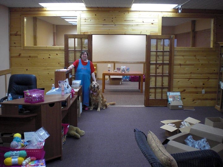 Debi and Barnabas in the store at Woodland Park. The storefront with our logo painted on the windows.