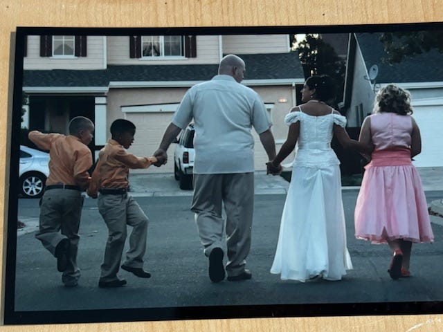 wedding photo with 5 people walking down street