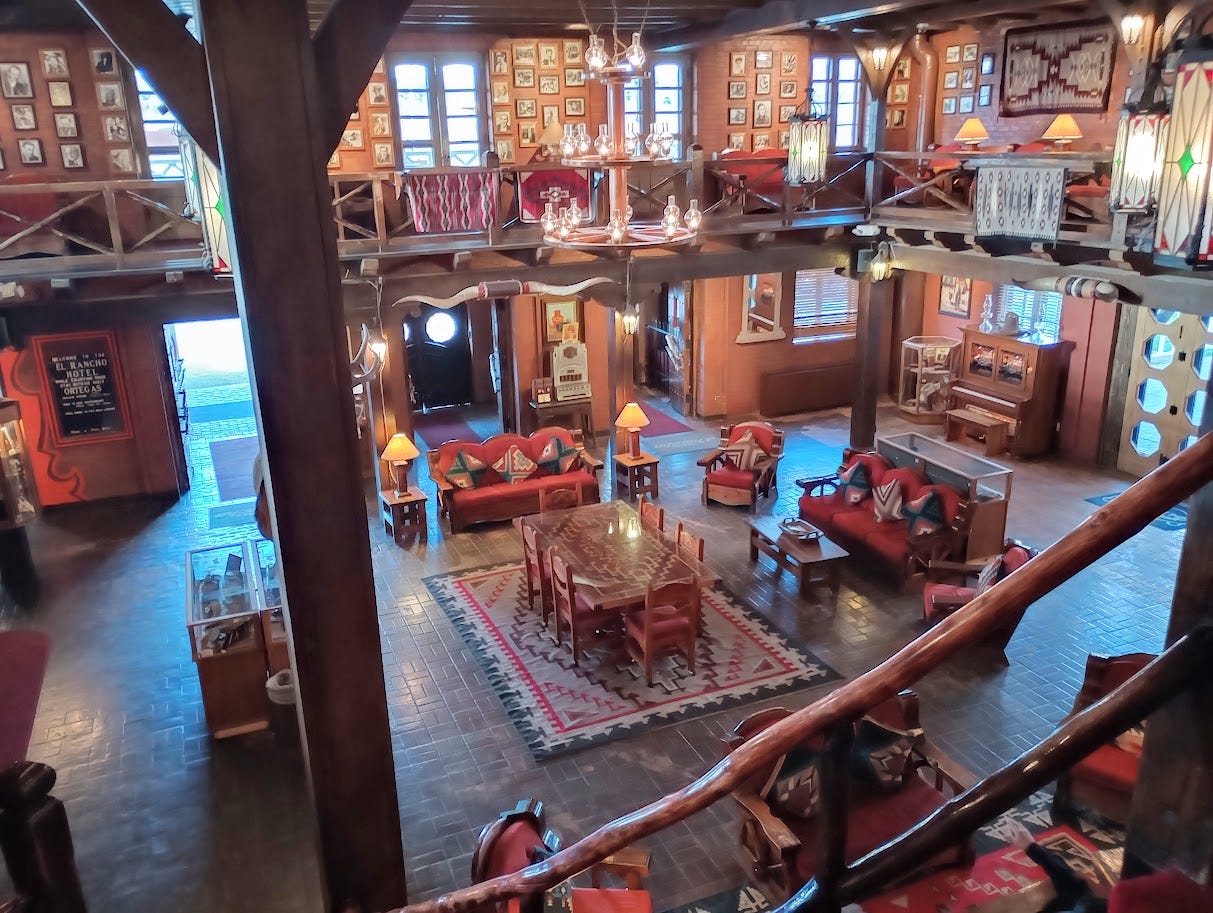 Large two story lobby with wood furniture and sofas, dozens of movie star photos on walls Large two story lobby with wood furniture and sofas, dozens of movie star photos on walls