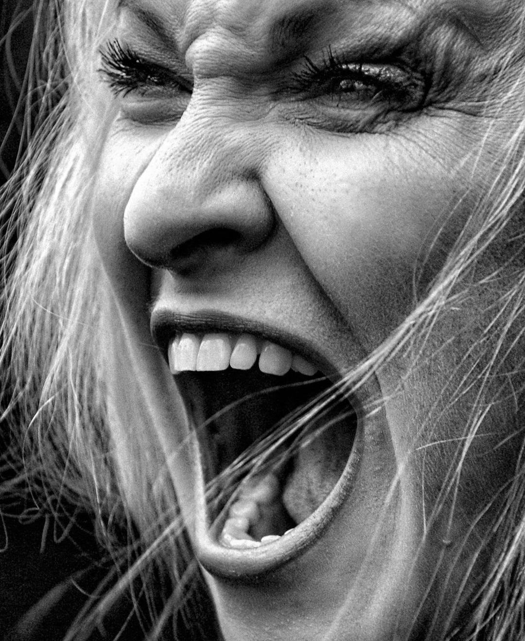 A woman screams with emotion in black and white. A woman screams with emotion in black and white.