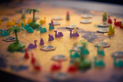 Spirit Island, For Science!, and Through the Desert, each in varying states of play.