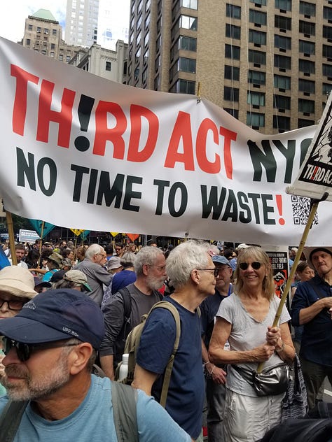 Six photos showing closeups of marchers with various banners and signs