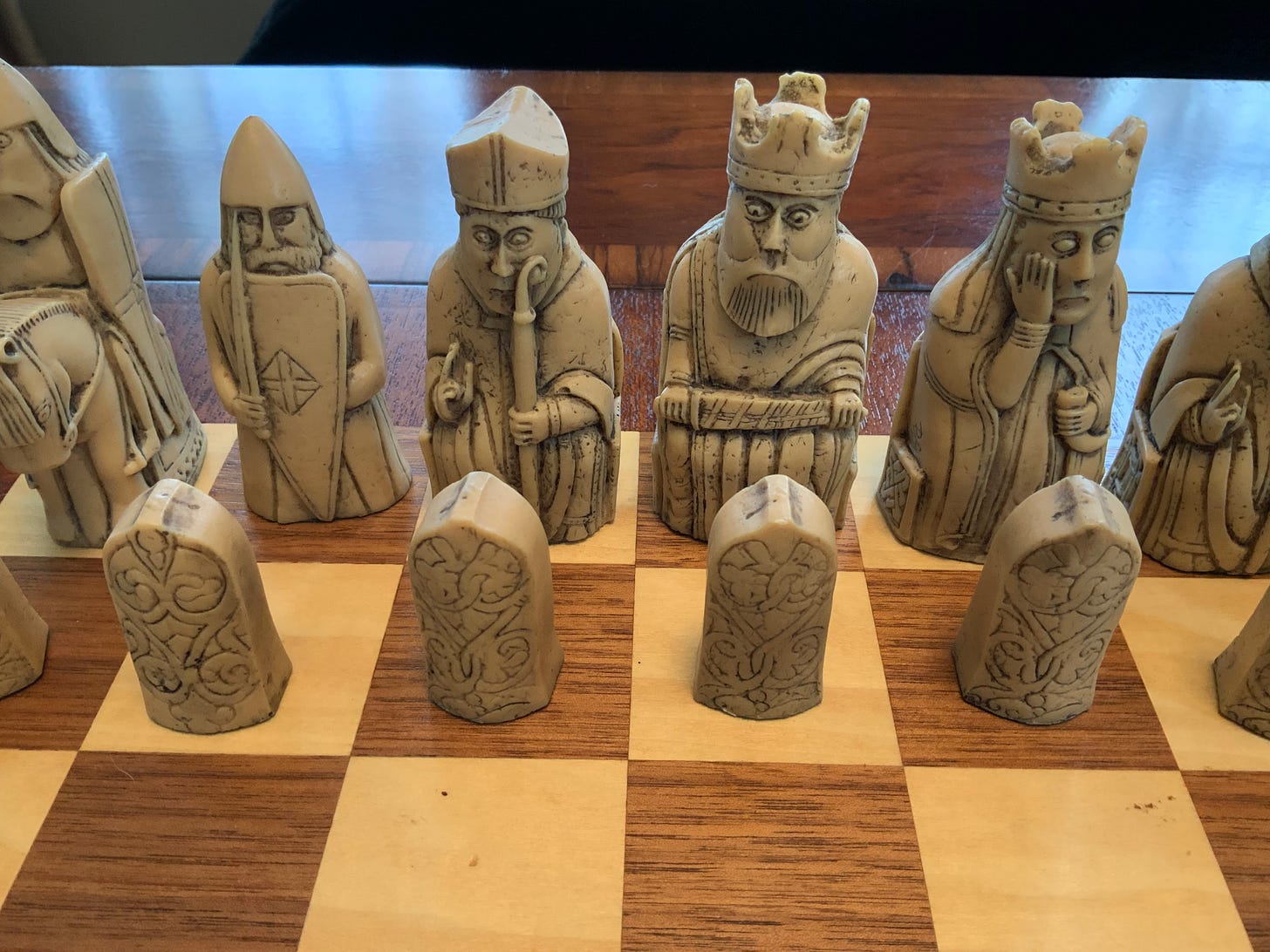 Replica Isle of Lewis chess pieces on a chess table