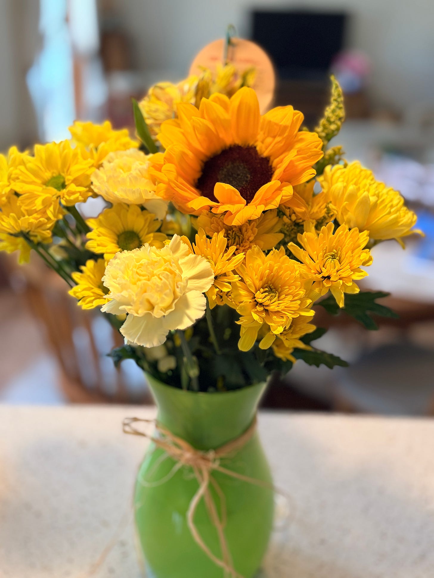 60 Things I've Learned at 60: a beautiful yellow flower bouquet in a green vase