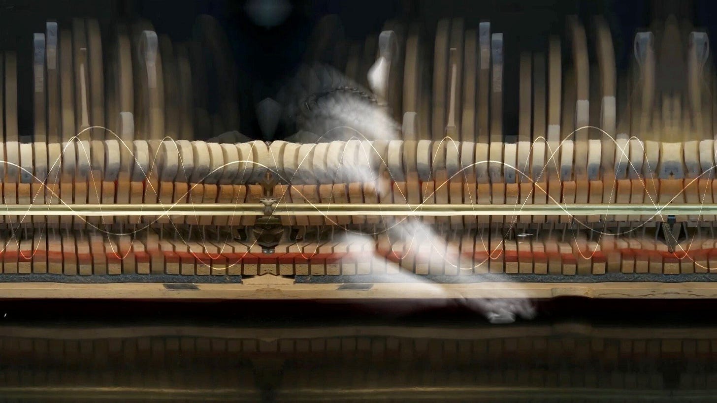 Still image from film: ‘Song Without Words’ by Olivia Ting. A faint image of a pianist is overlaid footage of the inside of a piano. Still image from film: ‘Song Without Words’ by Olivia Ting. A faint image of a pianist is overlaid footage of the inside of a piano.