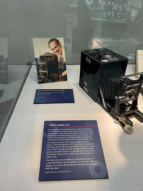 Image 1: Black and white panoramic photos documenting American history through the 70's|| My Apple Watch that I bought from the Carnegie Store|| Opened copy of Fourth Wing while I was reading it || An old Panoramic camera|| Negative film of a photo lined up with it's print|| the welcome area at the Apple store where people learn about Apple products