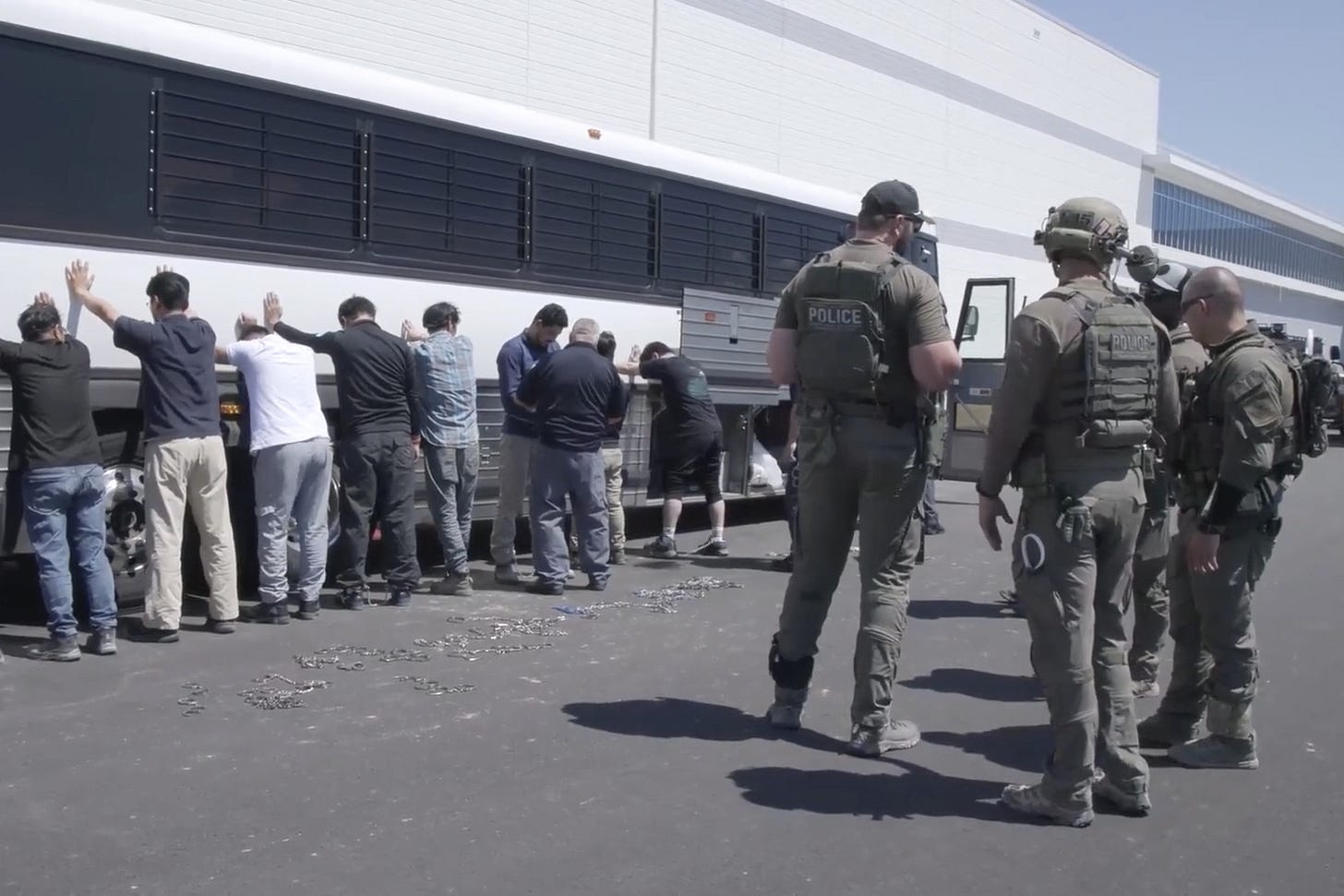 This image from video provided by U.S. Immigration and Customs Enforcement via DVIDS shows manufacturing plant employees waiting to have their legs shackled at the Hyundai Motor Group’s electric vehicle plant, Thursday, Sept. 4, 2025, in Ellabell, Ga. (Corey Bullard/U.S. Immigration and Customs Enforcement via AP) This image from video provided by U.S. Immigration and Customs Enforcement via DVIDS shows manufacturing plant employees waiting to have their legs shackled at the Hyundai Motor Group’s electric vehicle plant, Thursday, Sept. 4, 2025, in Ellabell, Ga. (Corey Bullard/U.S. Immigration and Customs Enforcement via AP)