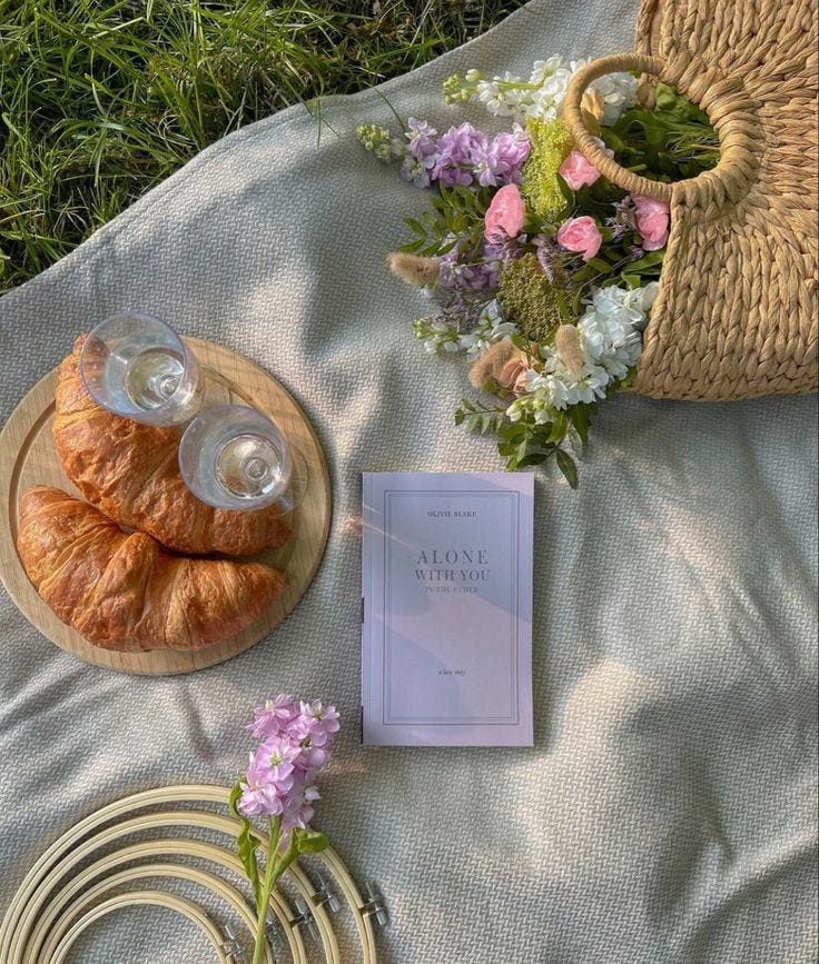 This may contain: the table is set with flowers and croissants