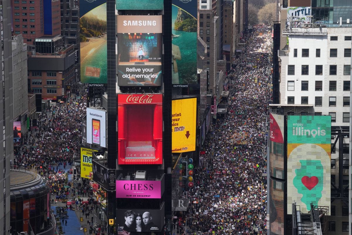 May be an image of Times Square, crowd and text May be an image of Times Square, crowd and text