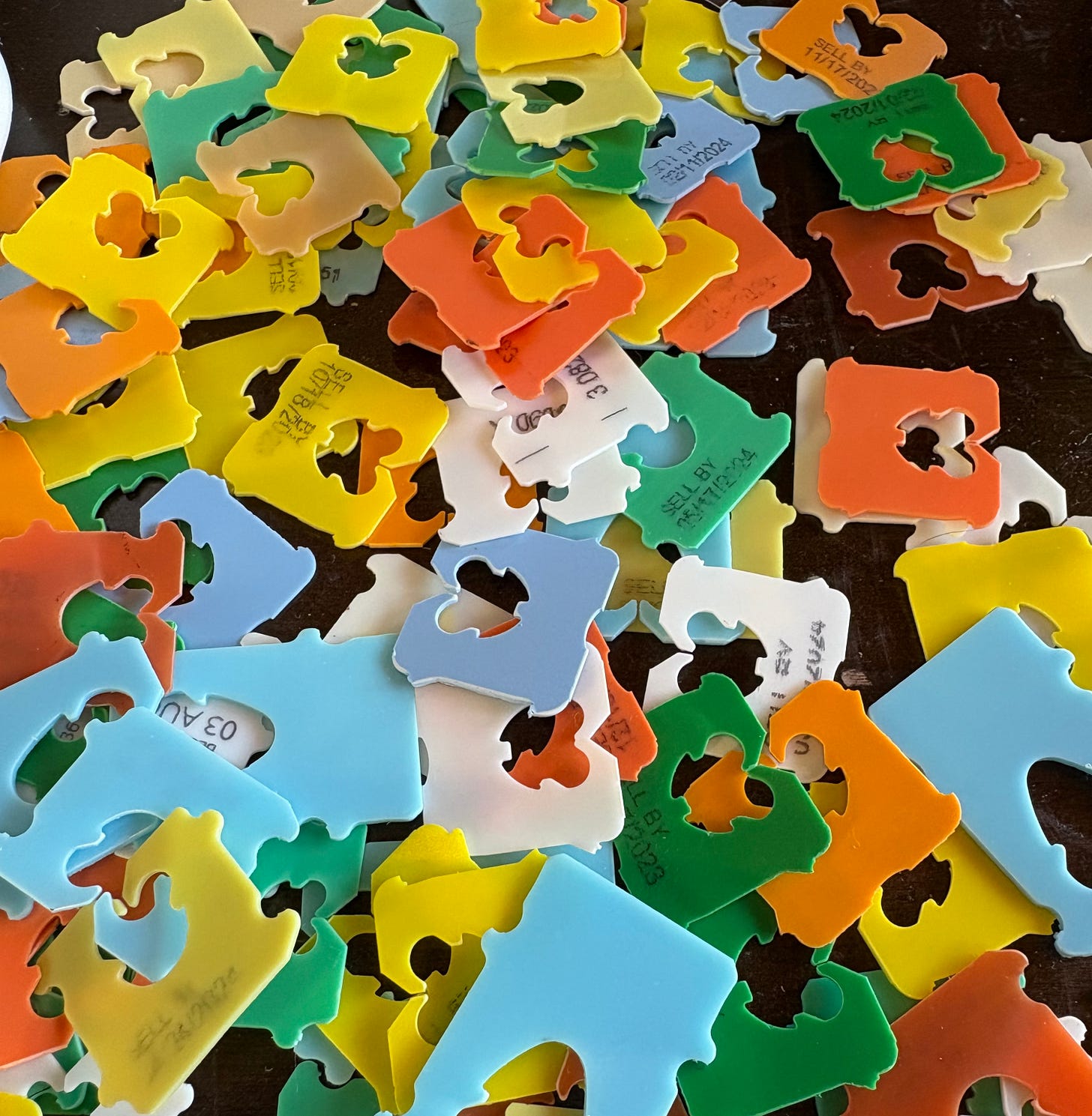 picture of plastic bread clips in various colors scattered across a table. so the reason i have a picture of bread clips is because i have OCD and one of the ways my OCD manifests is in collecting bread clips or bread tags or whatever you call those things that close bread bags sold at the store. i get very nervous when a bread bag loses a bread clip. and i get nervous too, when there are things in the world around me that slip toward tragedy and which i cannot control so what i do is squish down my concerns and worry and anxiety into the smallest thing i can imagine, and that is an obsession over bread clips. and a compulsion to collect them. so the context is THAT. but the content? it can best be iillustrated when my boyfriend asked why i was losing my shit over a lost bread clip. he said it doesn't really do anything for the bread. i replied but it's NOT about the bread clip! i need the bread clip but it's not about the bread clip! it just  needs to be on the bread. he replied, but the bread will be FINE. and i said NO! it will only be fine if the bread clip is on the bag and i know the bread will be fine but i still need th bread clip on the bag and then i had to explain the CONTEXT to him and then he finally UNDERSTOOD. Context versus Content, the END. did you read this? 