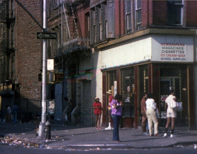 A group of people standing on a sidewalk

Description automatically generated
