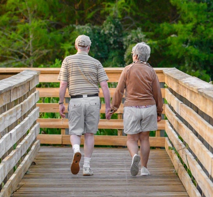 a couple of people that are walking across a bridge a couple of people that are walking across a bridge