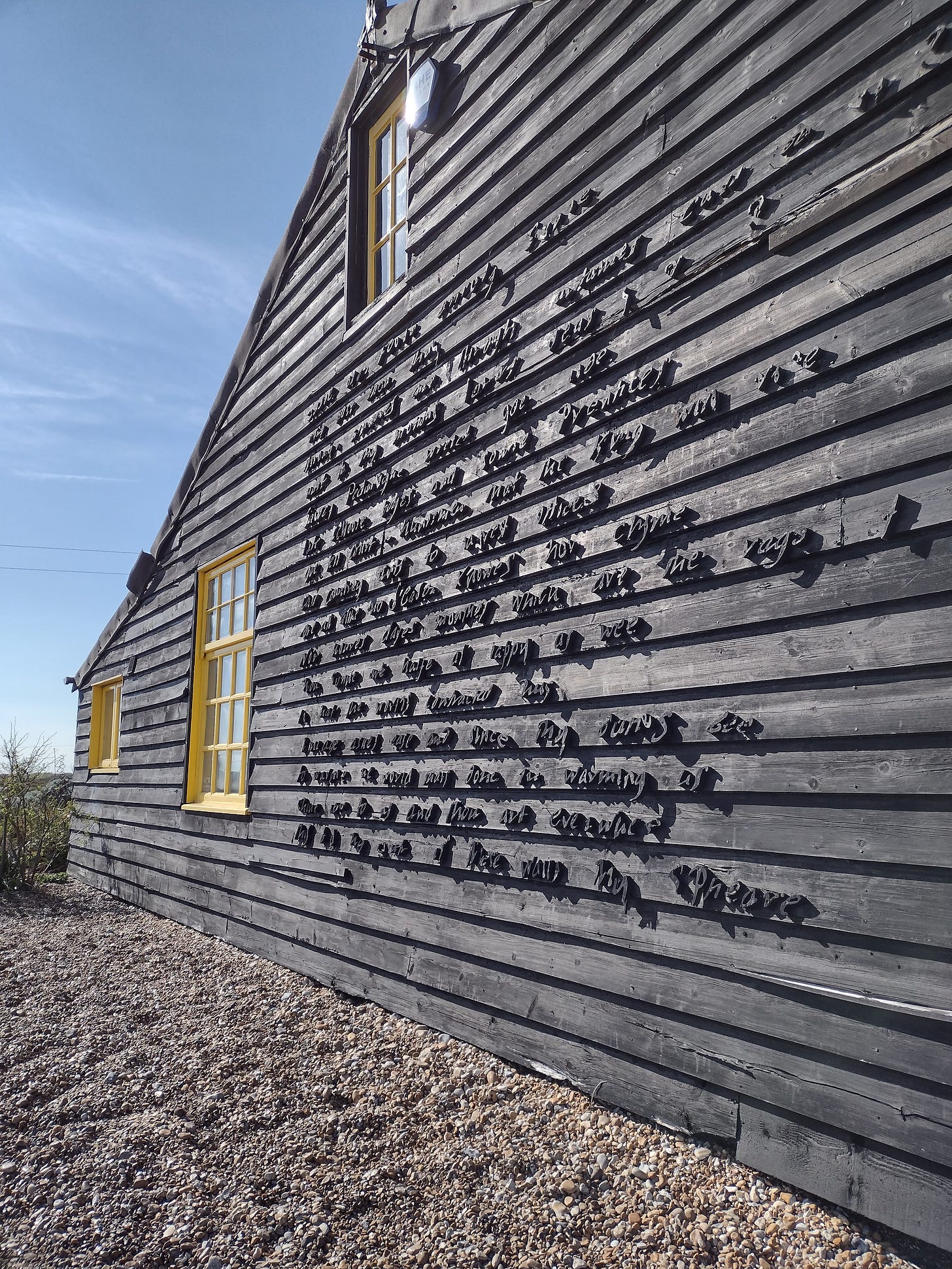 Derek Jarman’s last home, Prospect Cottage in Dungeness. On its black flanks, Jarman erected John Donne’s poem The Sun Rising. Nearly 40 years later, the words have partly rusted away, leaving fragments of words and verse behind.