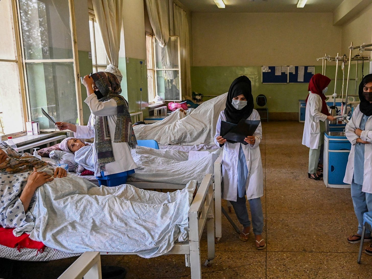 Healthcare workers attending to patients in an Afghan hospital ward amid the ongoing humanitarian crisis and funding shortages