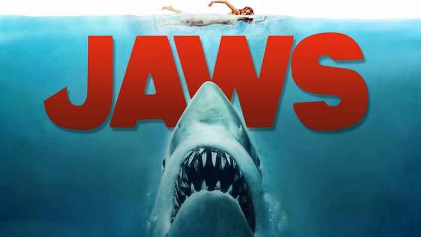 A woman unknowingly swimming above a shark in the film poster for Jaws