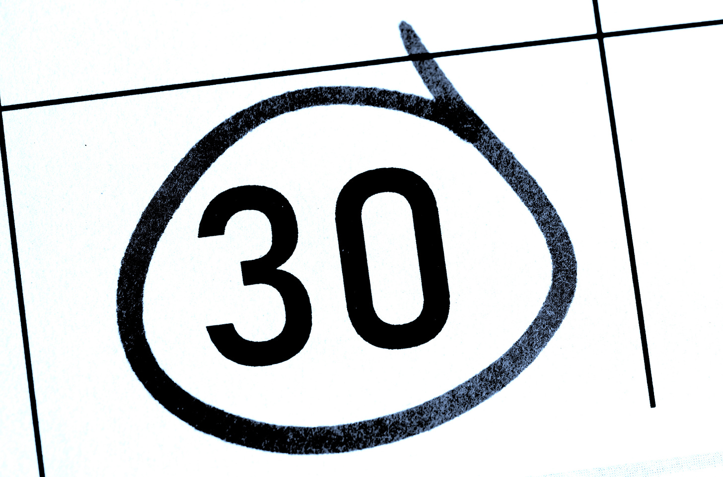 Black-and-white calendar close-up with the number 30 circled in thick marker, symbolizing a 30-hour work week. Black-and-white calendar close-up with the number 30 circled in thick marker, symbolizing a 30-hour work week.