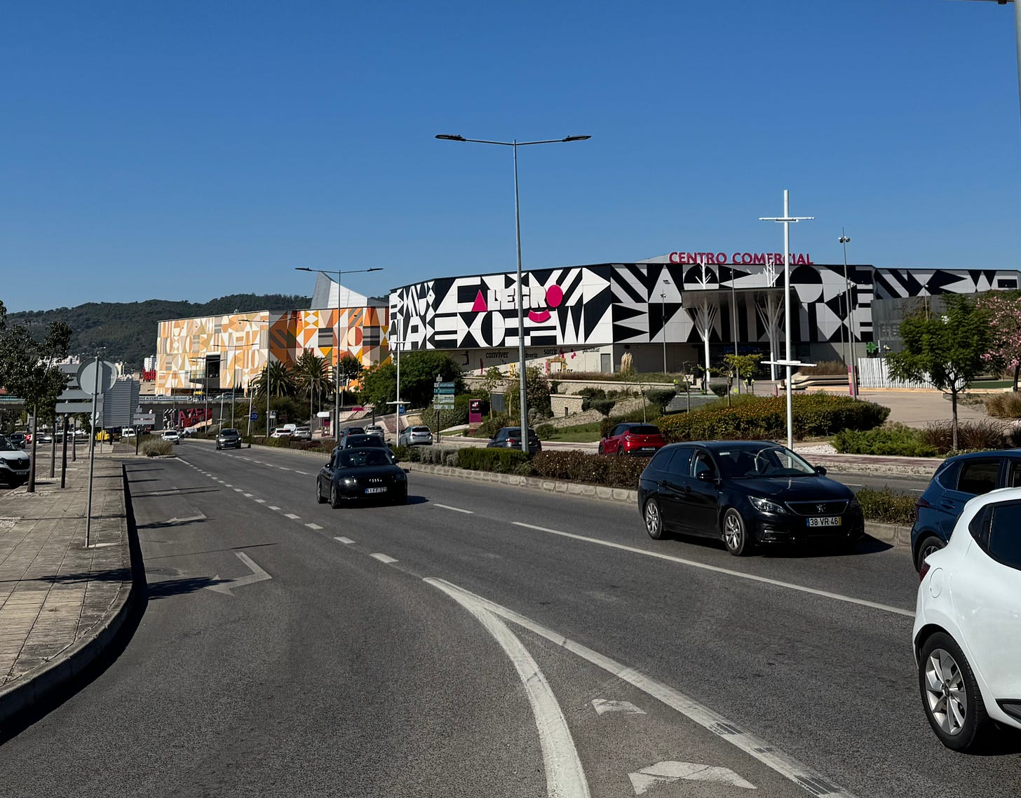 Cars on a busy street near a shopping mall. Cars on a busy street near a shopping mall.