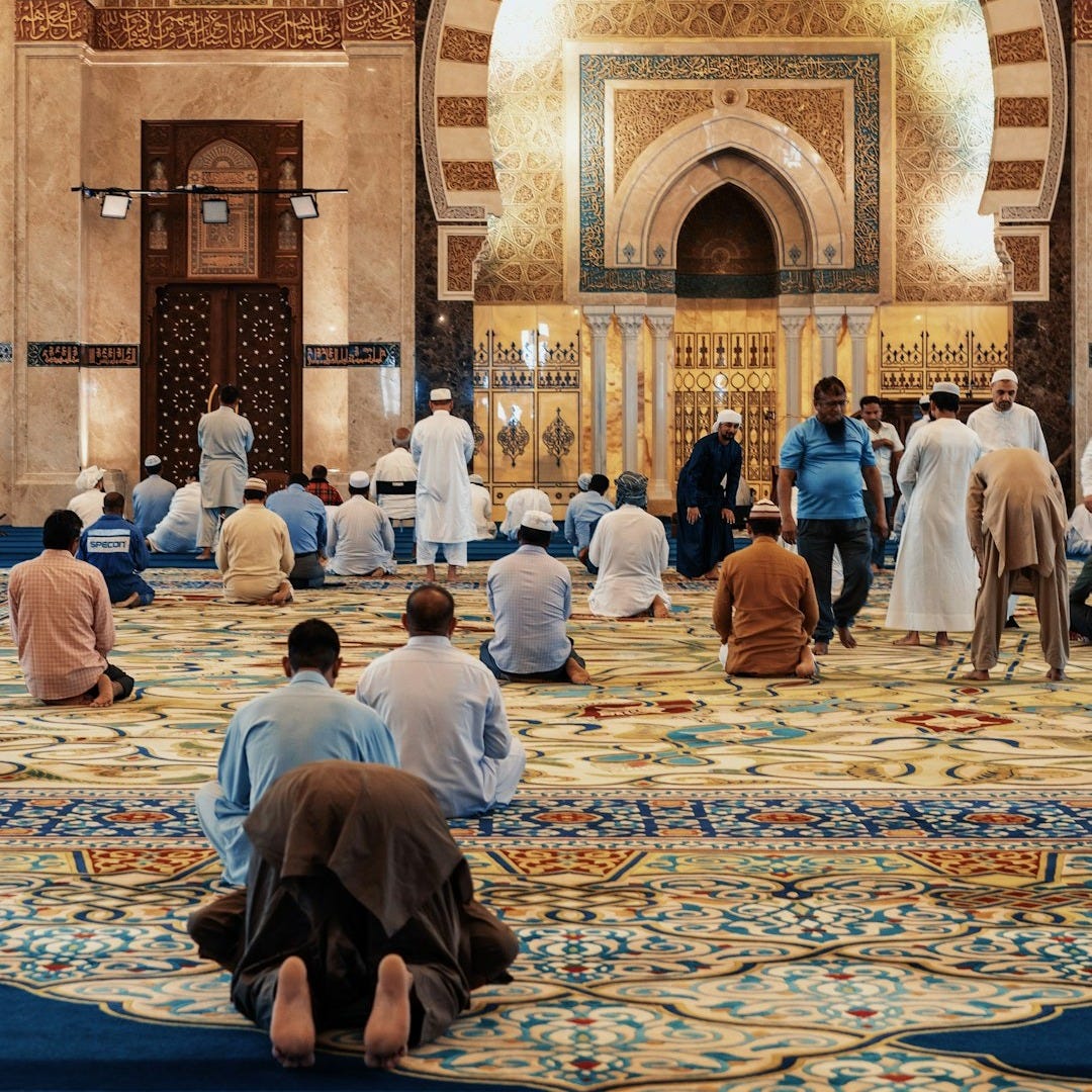 men kneeling and bowing inside building men kneeling and bowing inside building