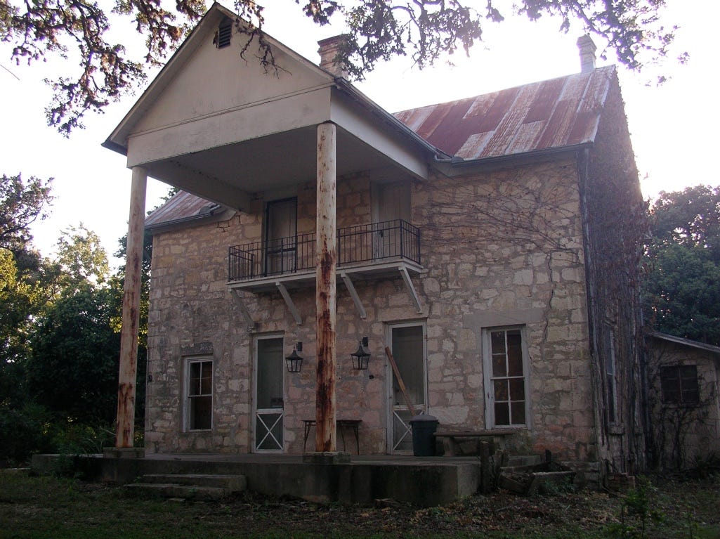 A stone house with rusted pillars

AI-generated content may be incorrect.