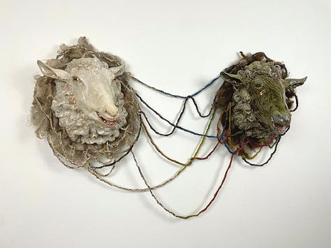 Installation views of a gallery with several artworks depicting sheep. All works are made of ceramic with fiber attachments connecting them together.