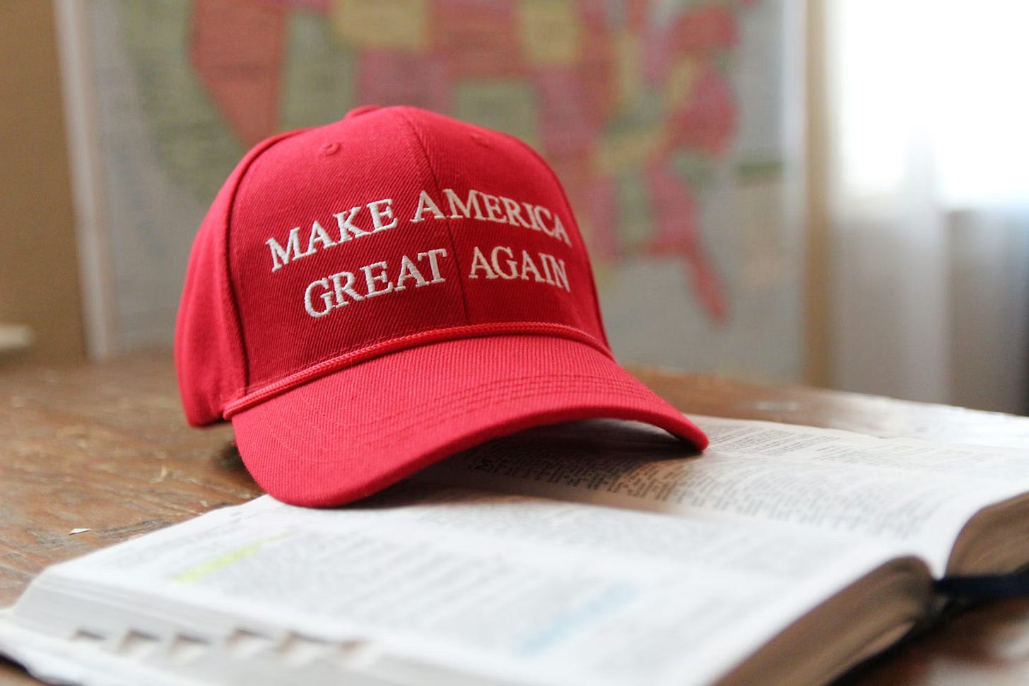 A "Make America Great Again" hat on top of a book. A "Make America Great Again" hat on top of a book.