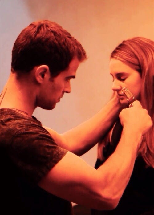 a still from Divergent where Four is injecting Tris with simulation serum