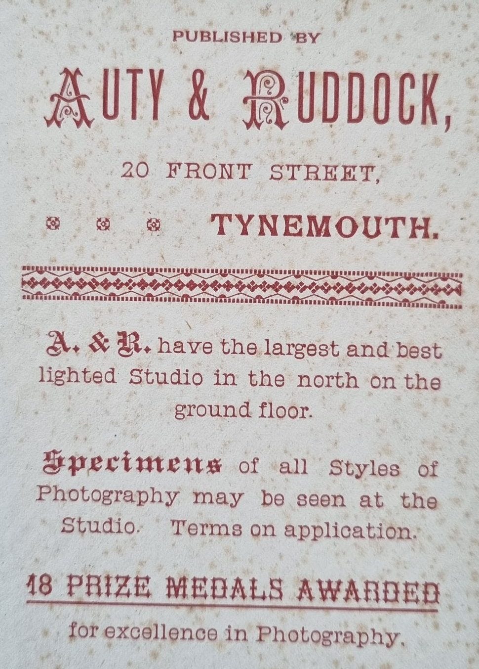 A vintage advertisement for Auty & Ruddock, a photography studio located at 20 Front Street, Tynemouth, promoting their services and showcasing their awards.