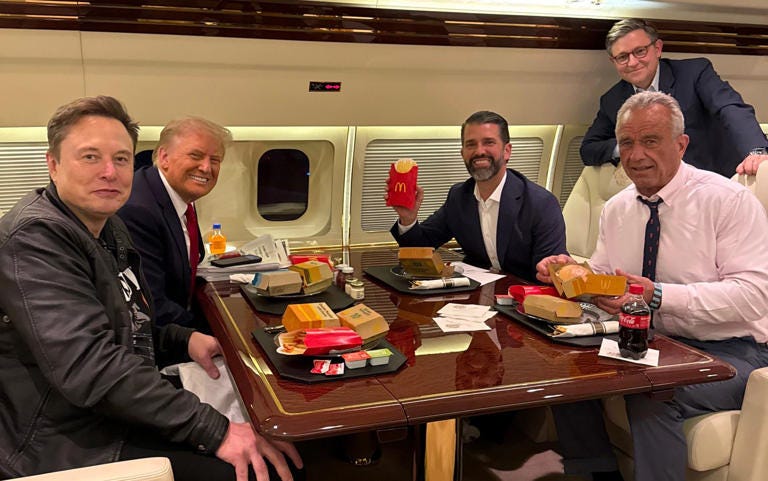 Donald Trump, his son Donald Jr, RFK Jr and Elon Musk with their McDonald’s meal on their way to the UFC fight - Margo Martin