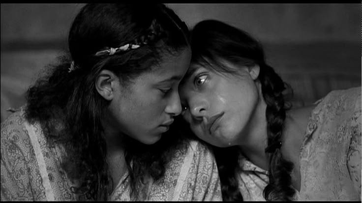 This may contain: two women are looking at each other with their eyes closed and one is holding her head