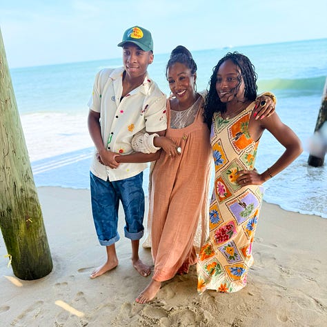 Shaunda Necole with her family under the Virginia Beach pier during a family cookbook photoshoot, capturing generational connection, heritage, and the heart of The Soul Food Pot®