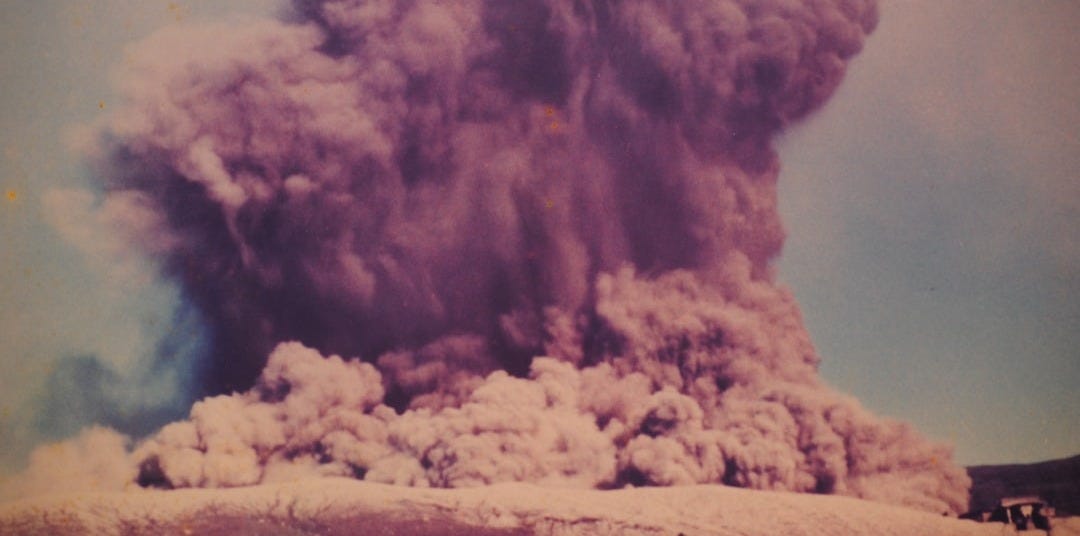 A massive plume of smoke rises skyward.