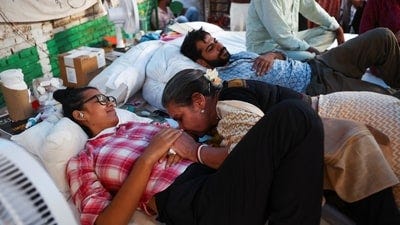 Indian actor Shabana Azmi kisses the hand of the fasting Indian student activist Neha Bora at the protest site after the Indian education reformer Sonam Wangchuk. (REUTERS)